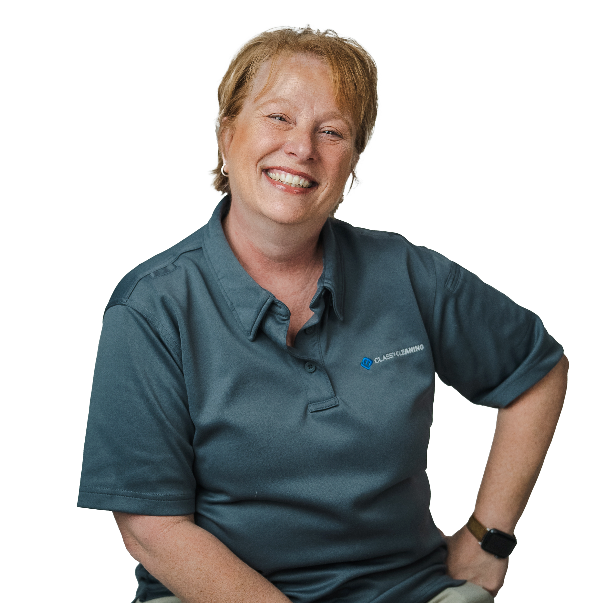 A smiling woman with short blonde hair wearing a dark blue polo shirt with a logo and text, looking at the camera.