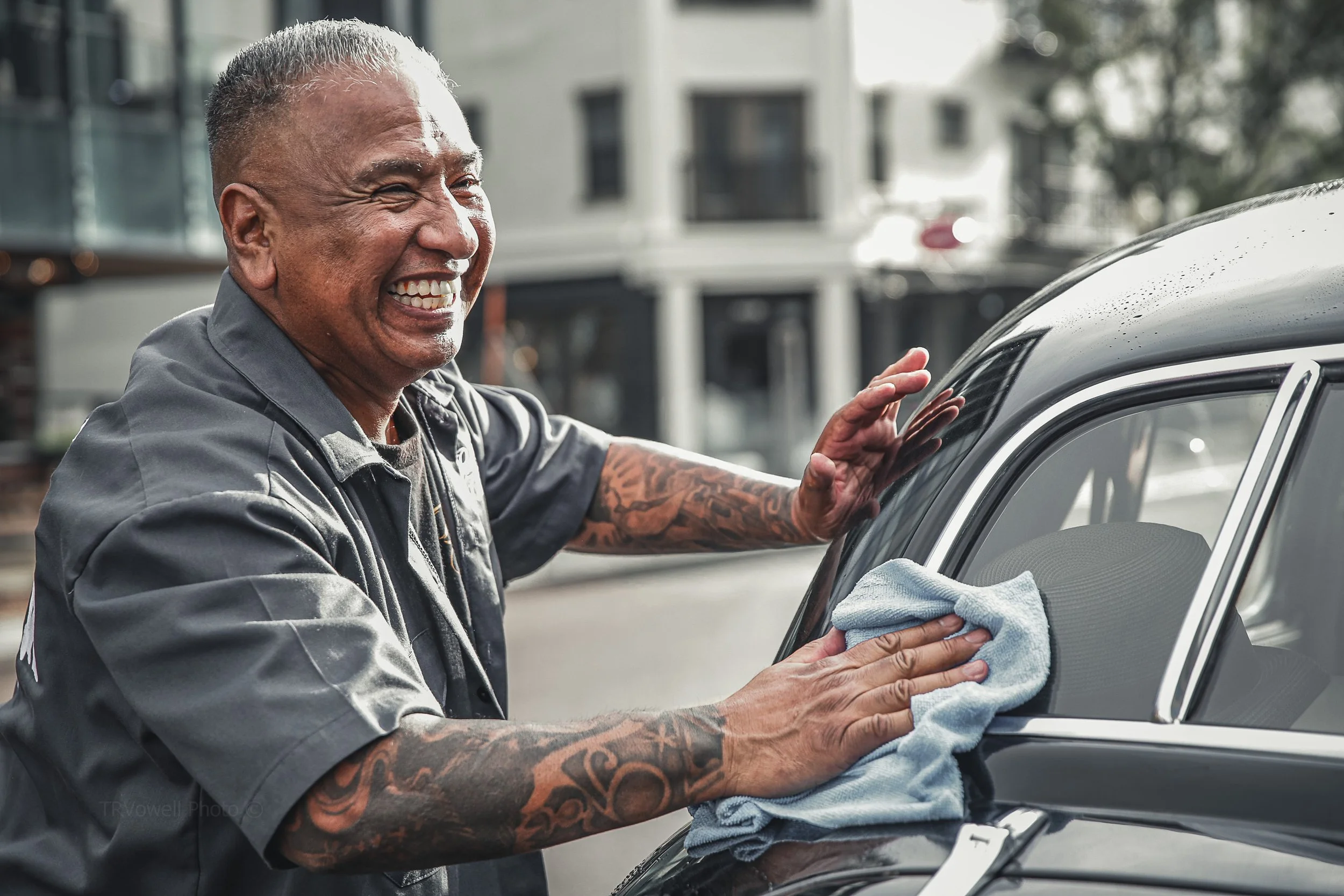 Documentary Candid Street Portrait of man showing off his classic car in Denver Colorado.  For local business profile email campaign social media