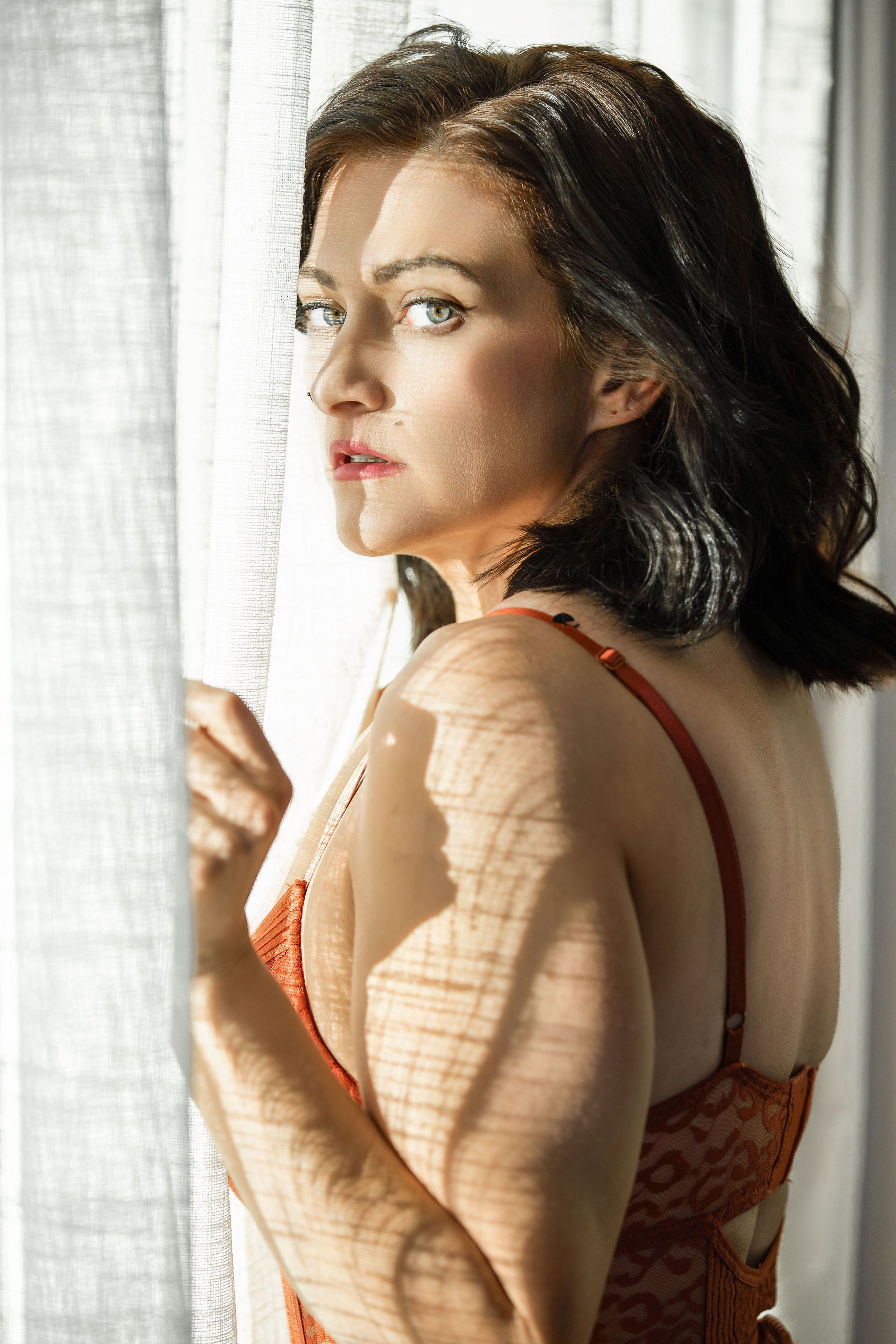 Natural-light portrait of a woman by a window.