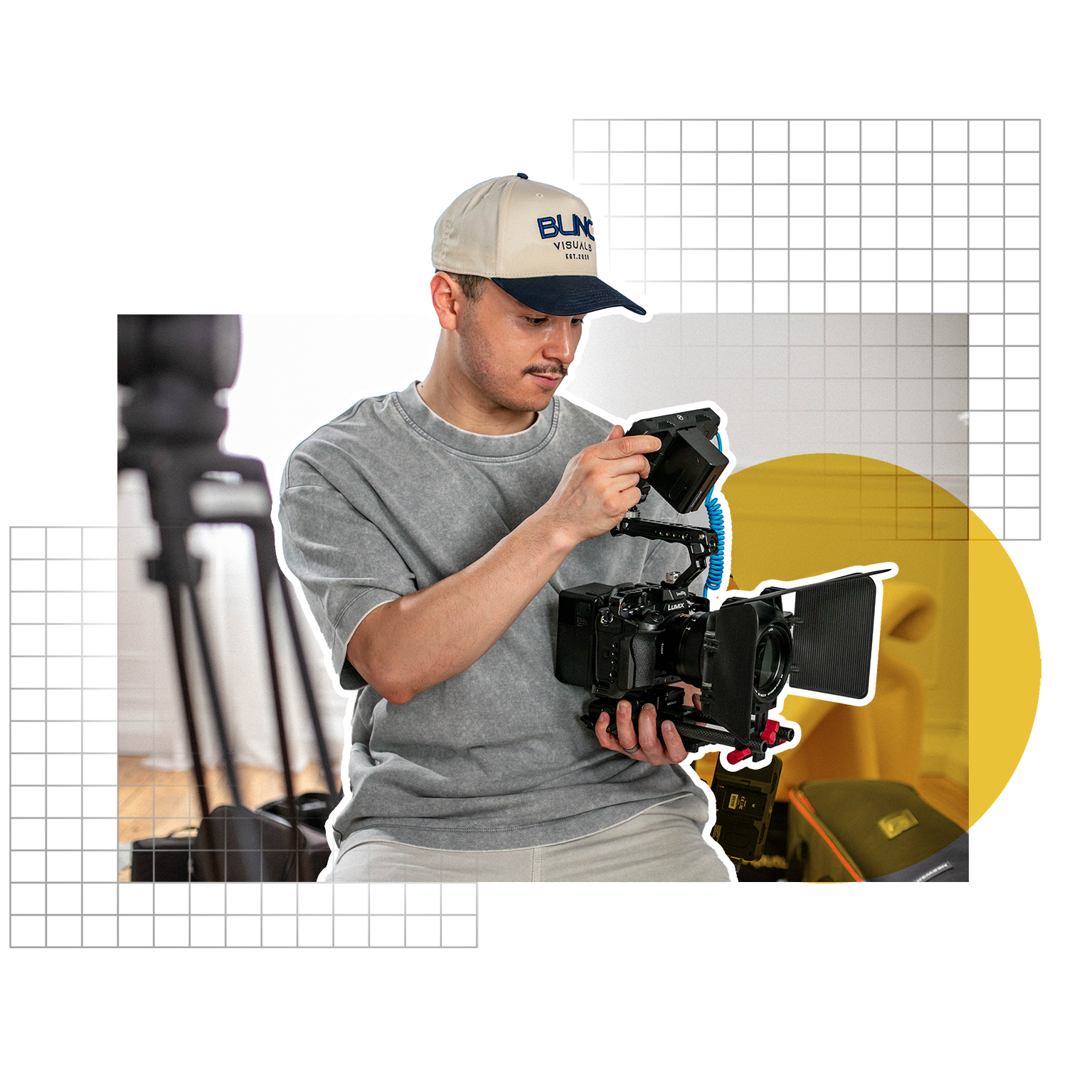 A man working with professional video equipment in a studio.
