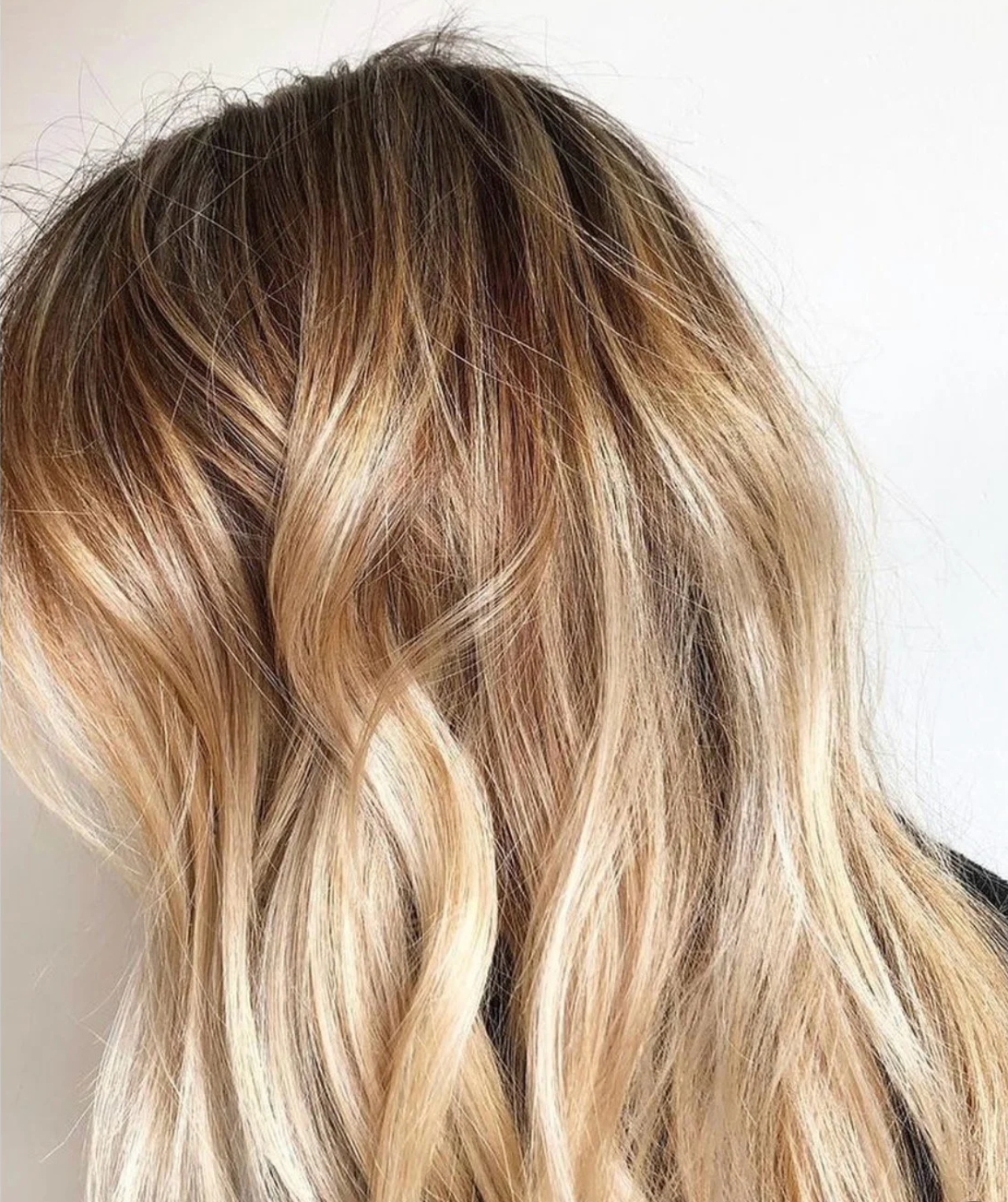 A close-up view of bright, dimensional blonde balayage highlights with a seamless root smudge at Little Saint Salon in the Kerns neighborhood