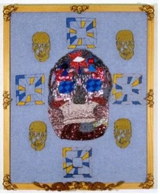 The art of Duyen Nguyen represented by Bywater Art Gallery of New Orleans during Mar-Ap 2026. A  beaded or mosaic art piece of a skull with blue eyes and red accents, surrounded by four skulls on a light blue background, framed in gold.