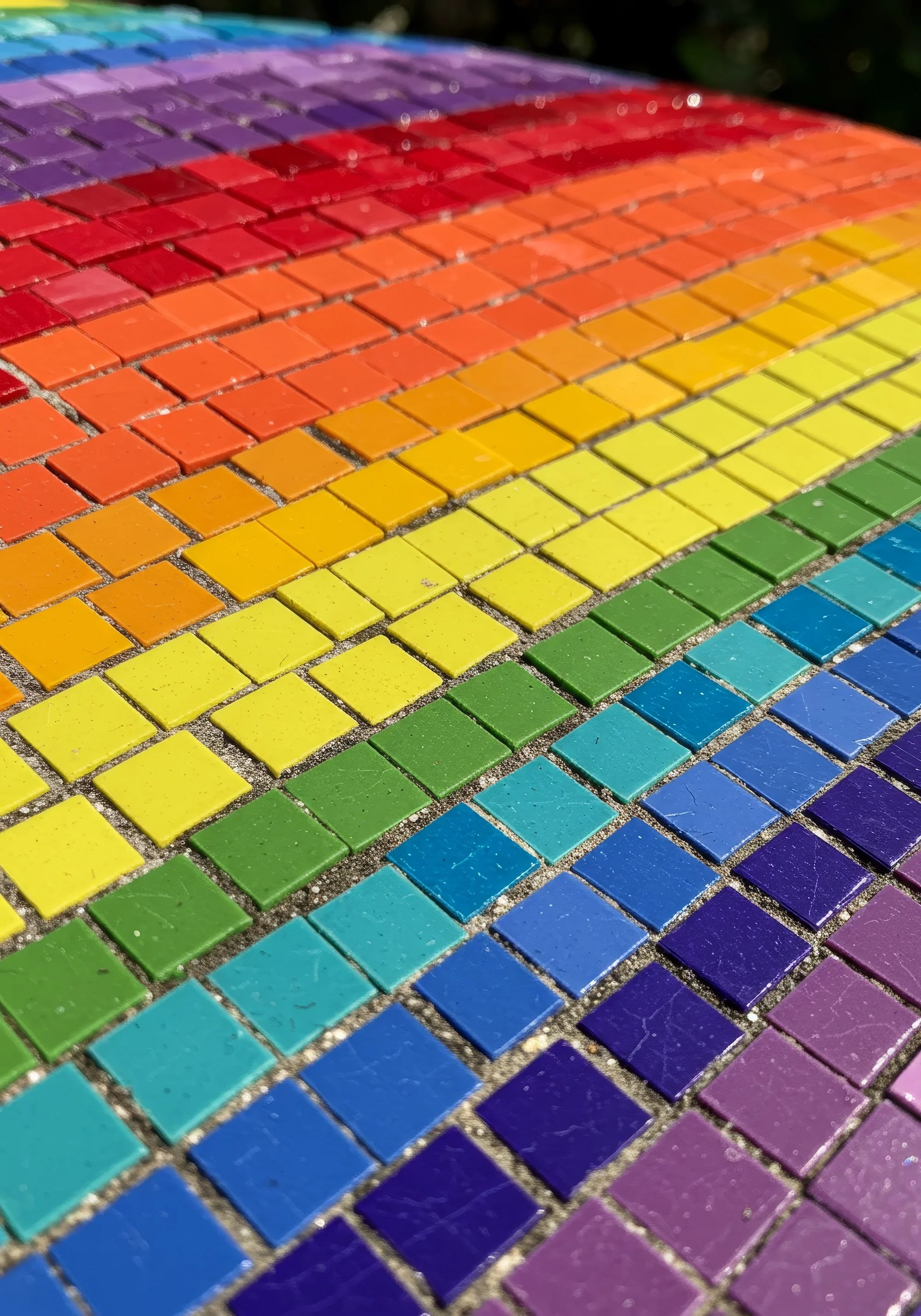 Rainbow-colored mosaic tiles arranged in a pride flag patternRainbow-colored mosaic tiles arranged in a pride flag pattern