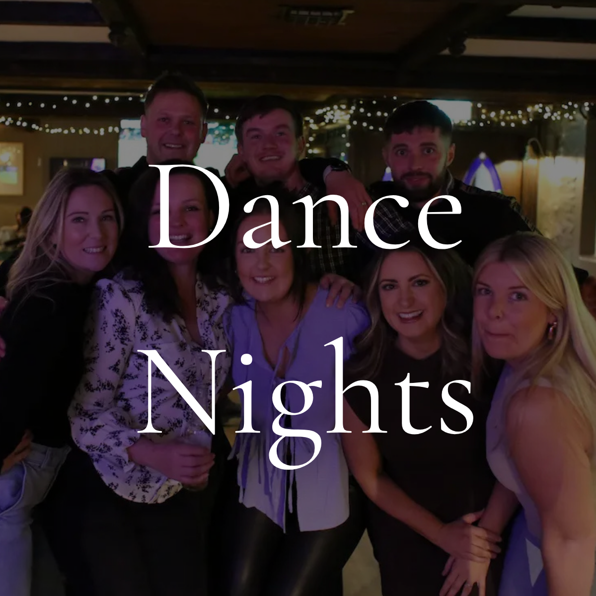 Group of people gathered in a dimly lit restaurant or bar, celebrating at a night out, with the words 'Dance Nights' overlayed on the image.