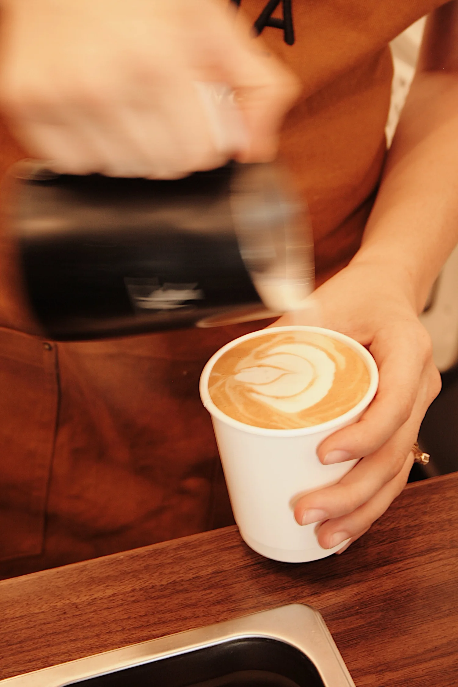 Barista pulling espresso shots and crafting latte art at a Vista Coffee Catering event in Philadelphia