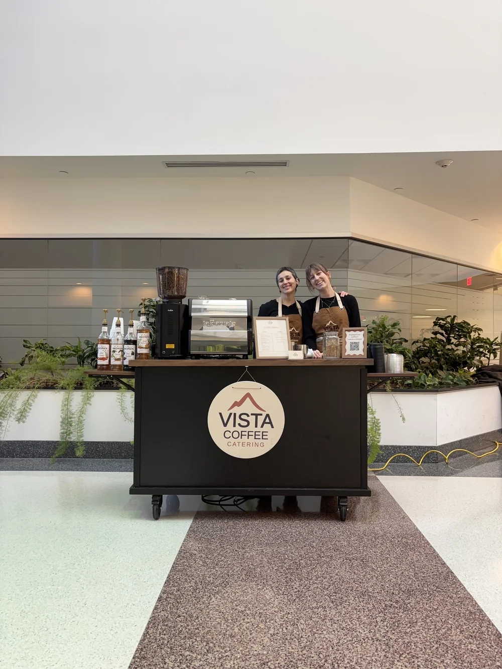 Guests smiling at the Vista Coffee Catering stand at a Philadelphia event