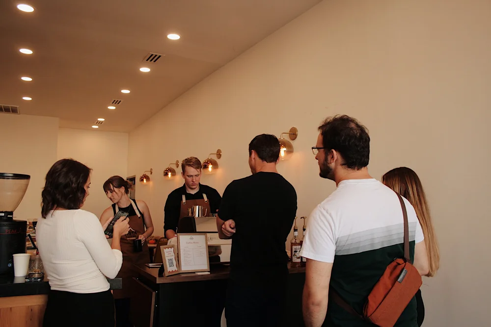 Guests lining up at the Vista Coffee Catering espresso bar during an office event