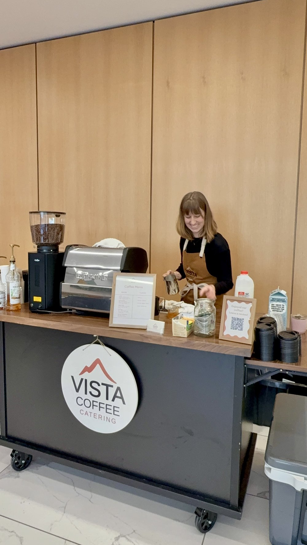 Vista Coffee Catering barista serving from the mobile coffee cart