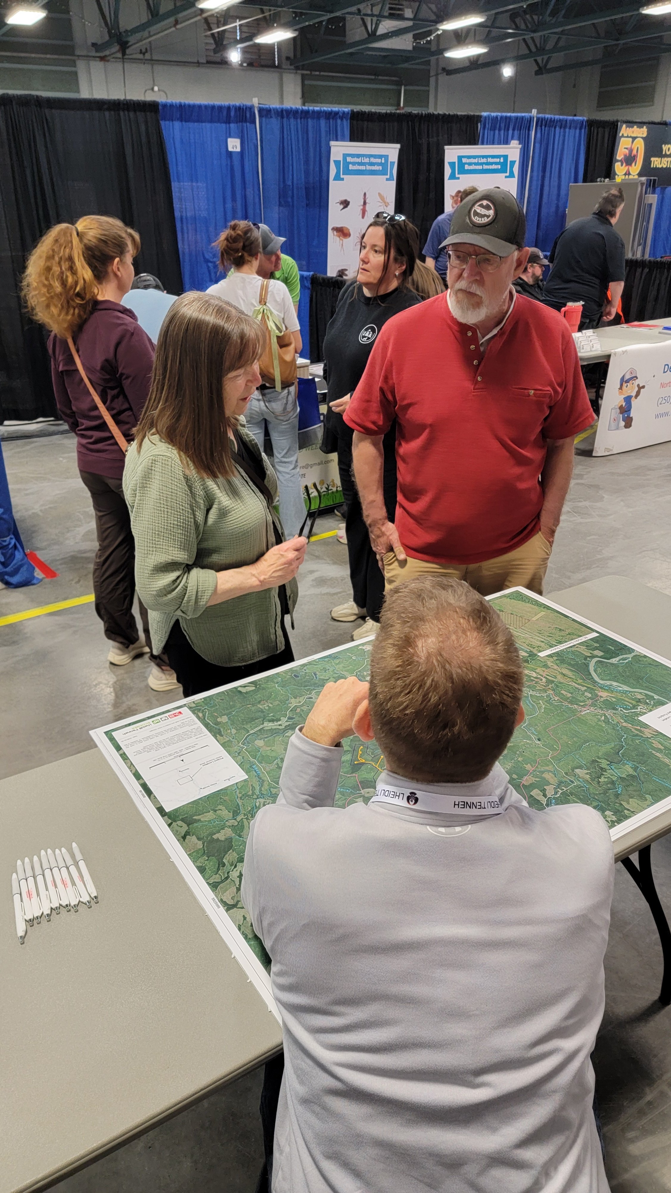 Dan chatting with community members, education on Nilhtsi Ecoener Wind Project at the Quesnel Trades Show 2026