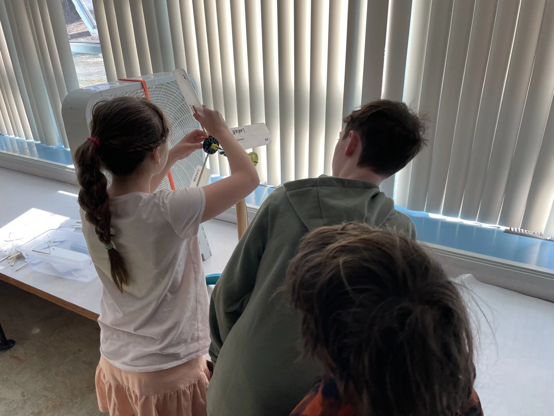 Students learning about Renewable Energy and wind turbines at Hixon Open House May 2026