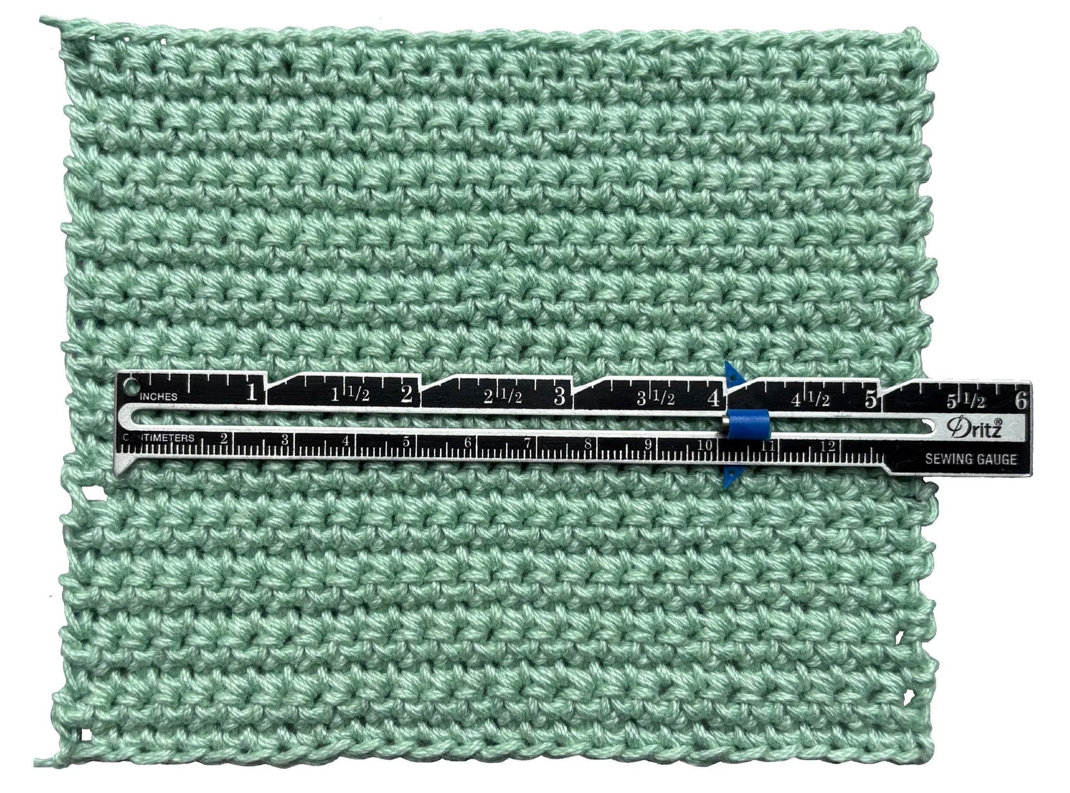Crochet gauge with a ruler showing measurements in inches and centimeters.
