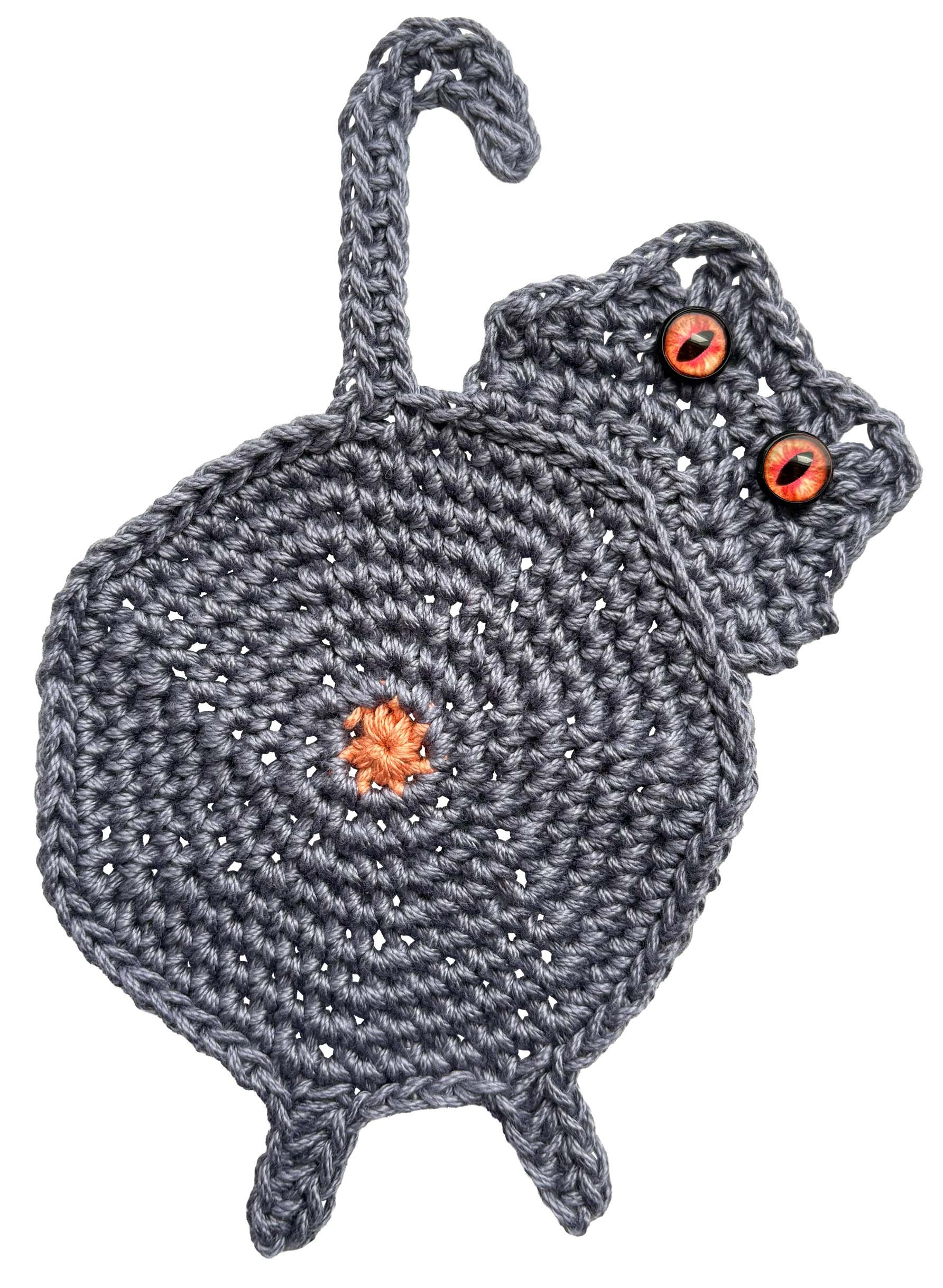 A crocheted cheeky cat motif with cat butt and buttons for eyes