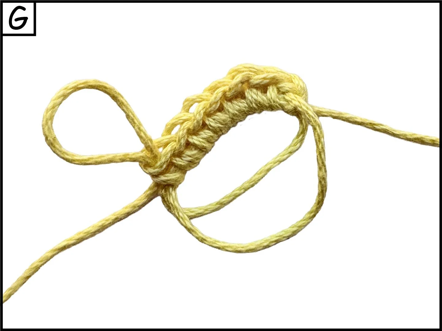 Close-up of yellow twisted rope tied in a knot on a white background.
