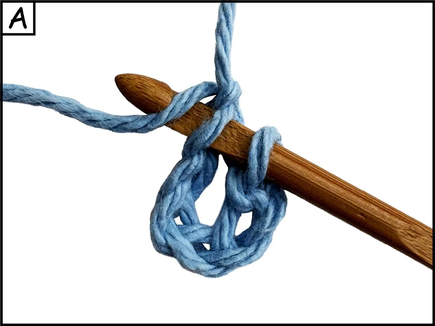 A wooden knitting needle with a blue yarn looped around it, forming a knot. The background is white.
