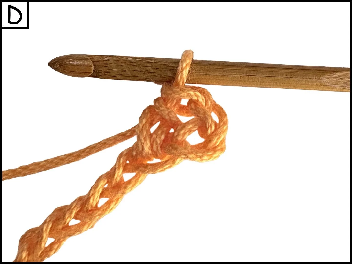 Close-up of orange yarn tied in a knot around crochet hook against a white background.