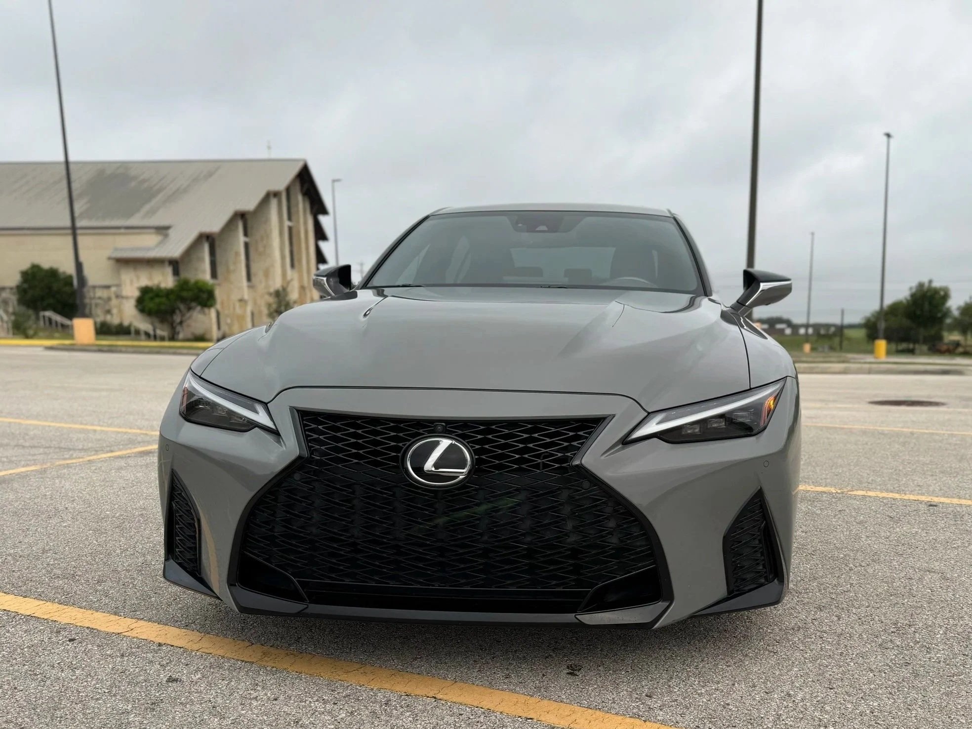 Gray Lexus IS500 V8 large in center with Church and sky in the background