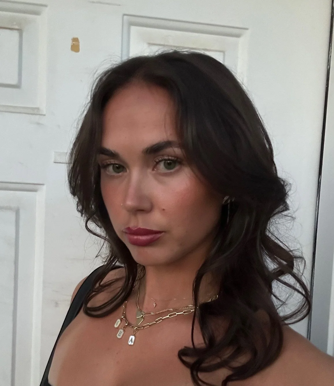 Sofie, a young woman with brown hair and a summer tan posing for selfie