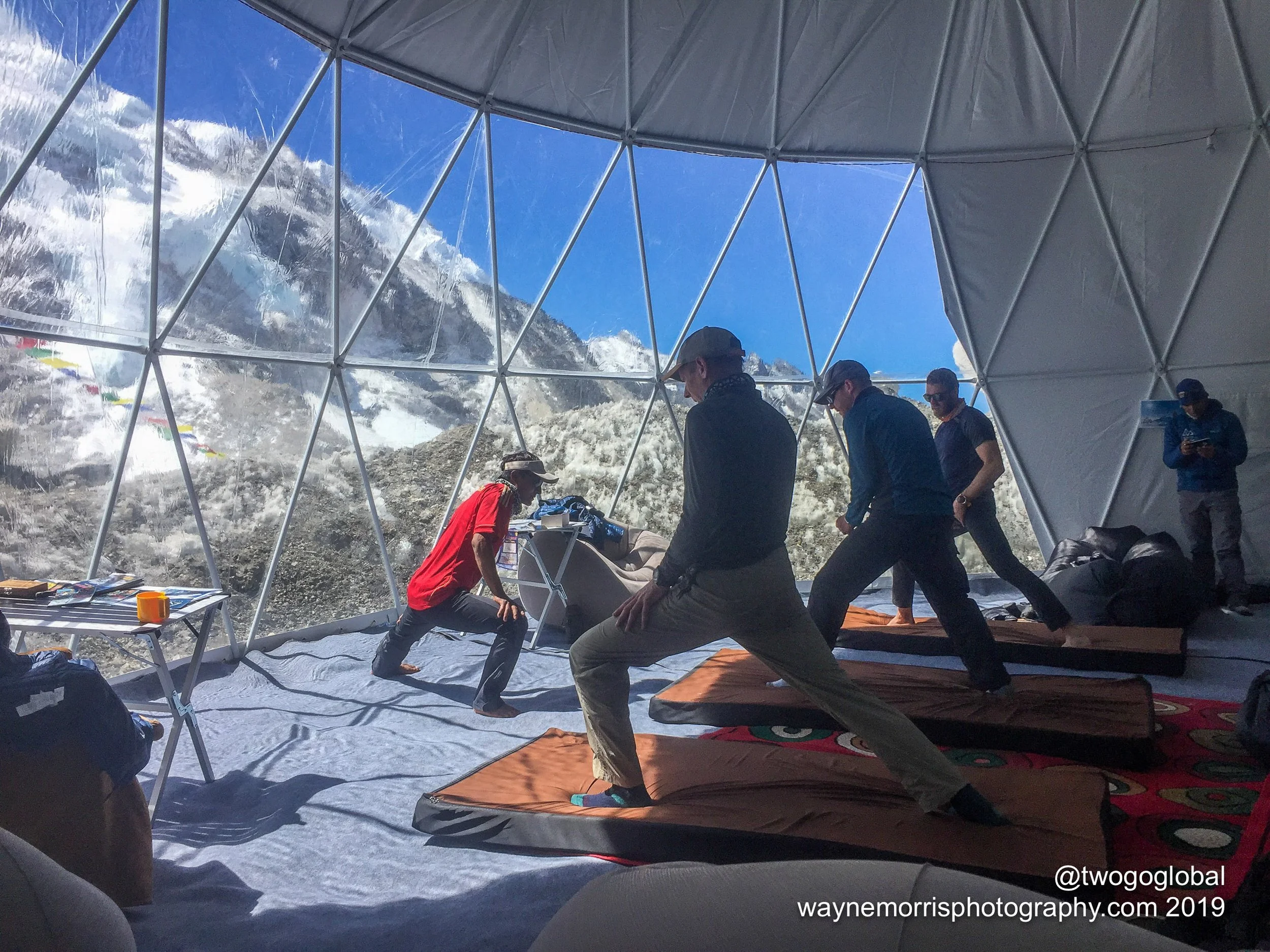 Yoga stretching session for climbers at Climbing the Seven Summits Everest Base Camp Big House