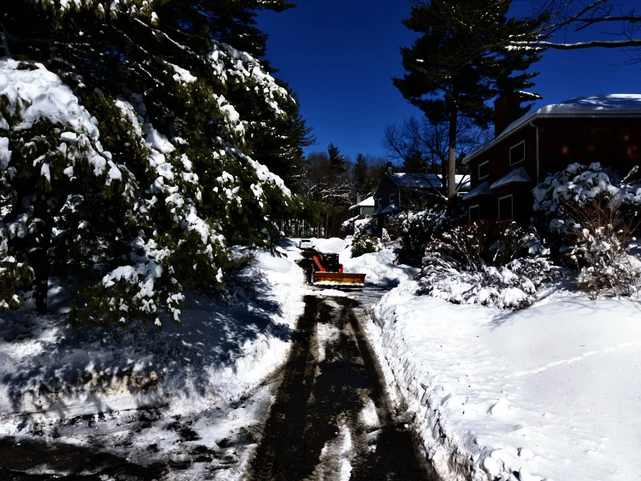 Drone, aerial photography of a recent snowfall in New England, Massachusetts, blizzard 2026, blue sky, snow