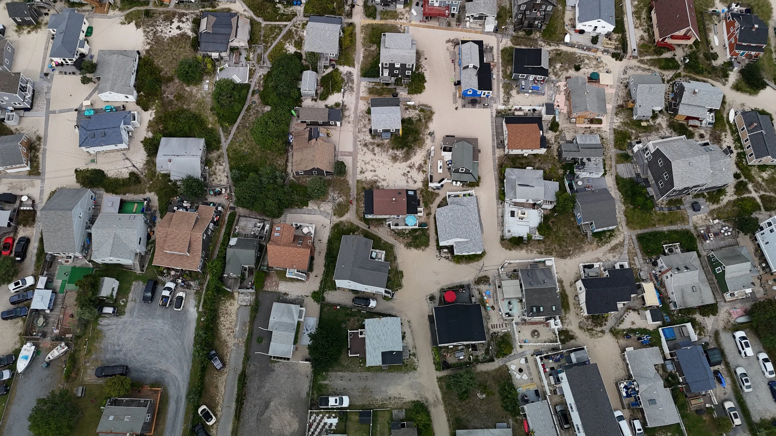 Altitude Drone Dynamics. A bird’s-eye view of a property’s layout, surrounding landscape, and proximity to amenities in Rhode Island.