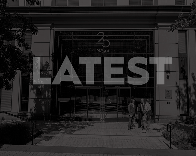 The image shows the front of 25 Massachusetts Avenue with large text "LATEST" overlaid on the images.