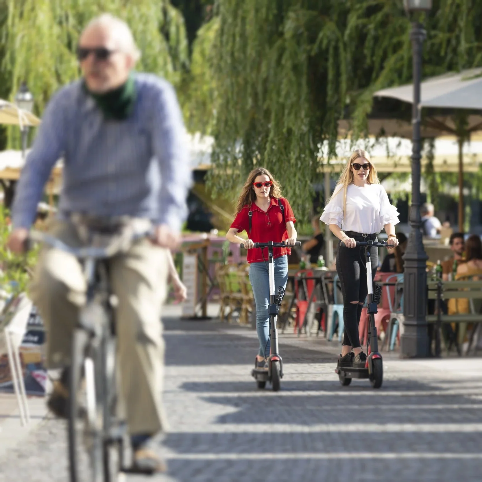 Multi-use path with cyclist and girls riding scooters