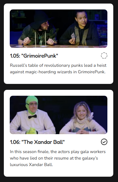 Two people dressed as wizards and a person in a tuxedo, sitting at a table in a darkroom setting.