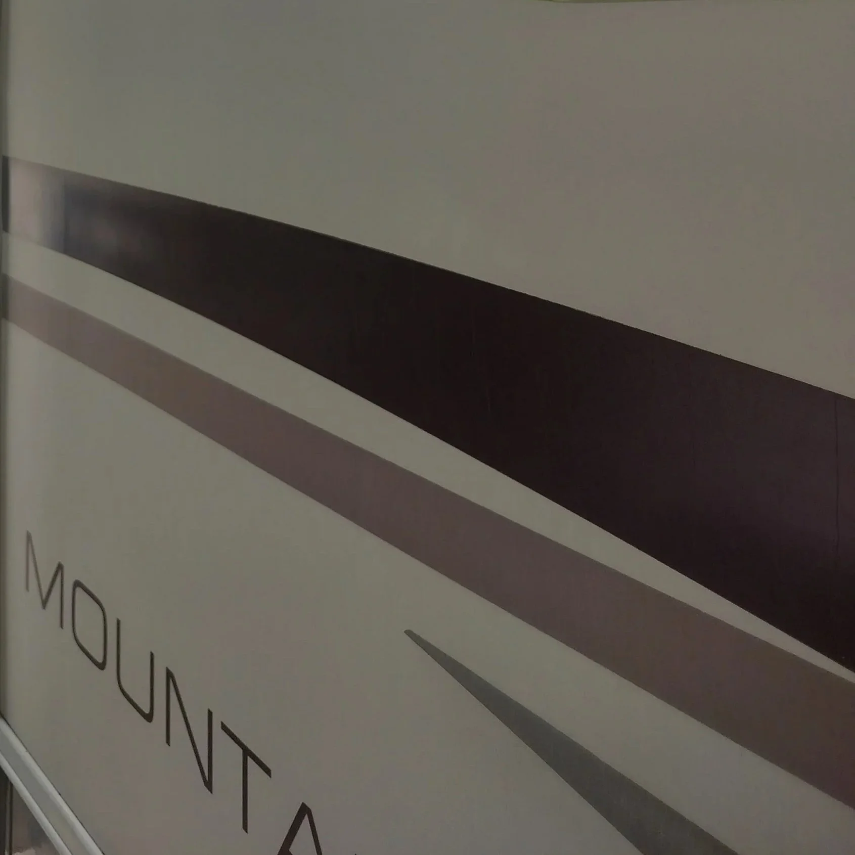 Close-up of a label for a mountain air conditioner unit with a black and gray stripe design.