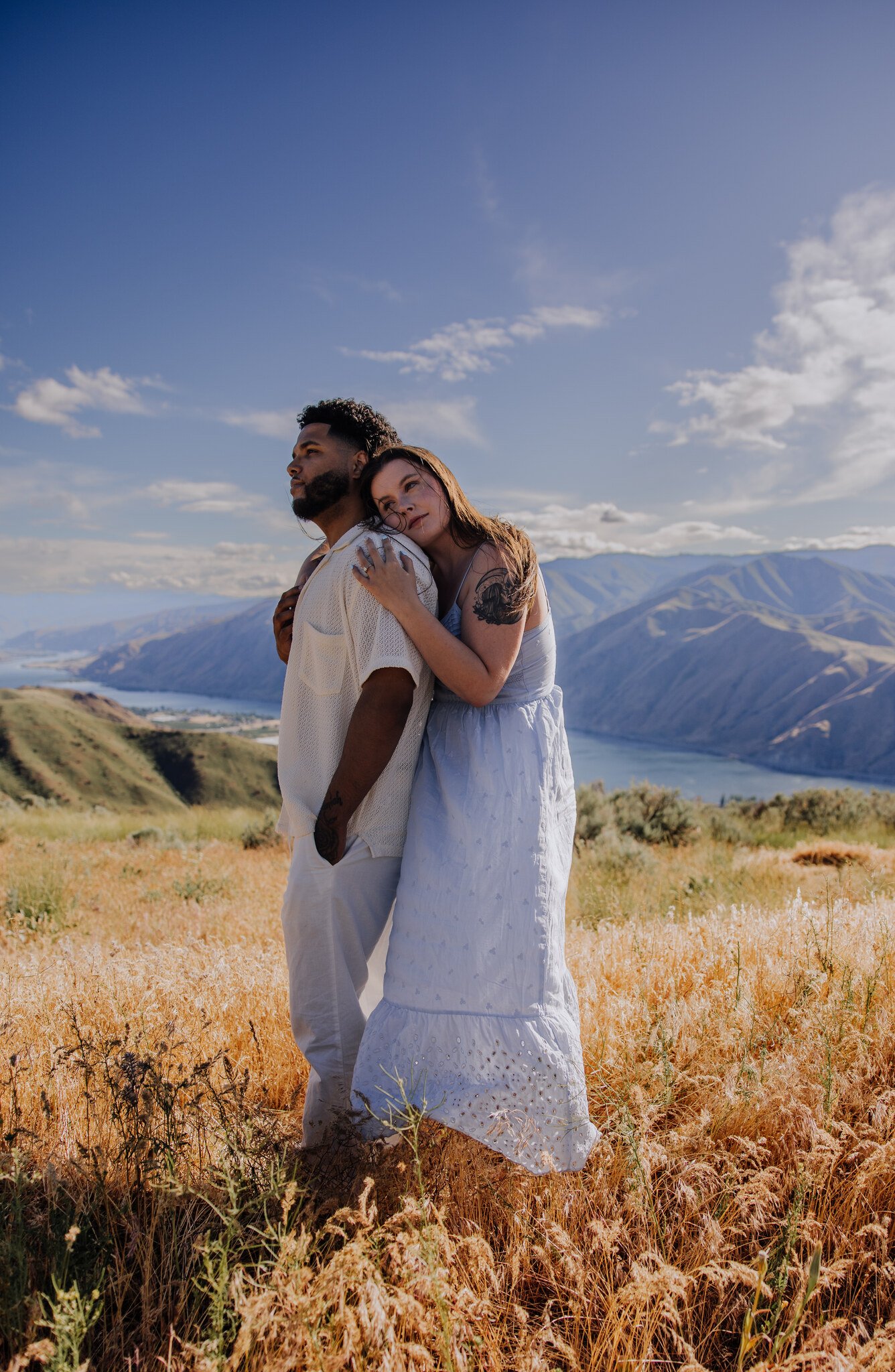 lake-chelan-engagement-photographer-couple-embrace-lake-view-13.jpg