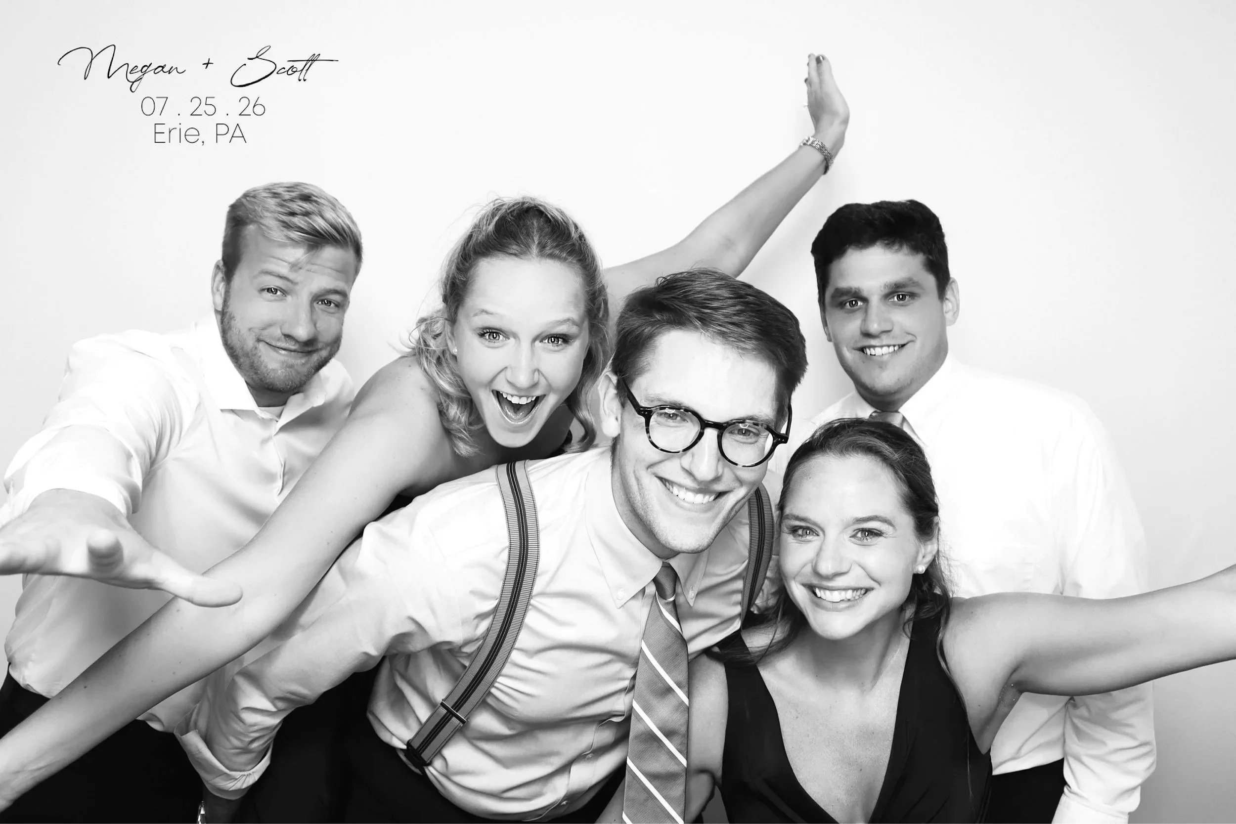 A group of six young adults taking a selfie together in a black and white photo. They are smiling and making lively expressions, with some leaning towards the camera and one person raising a hand in the background. The text above them reads "Megan + 