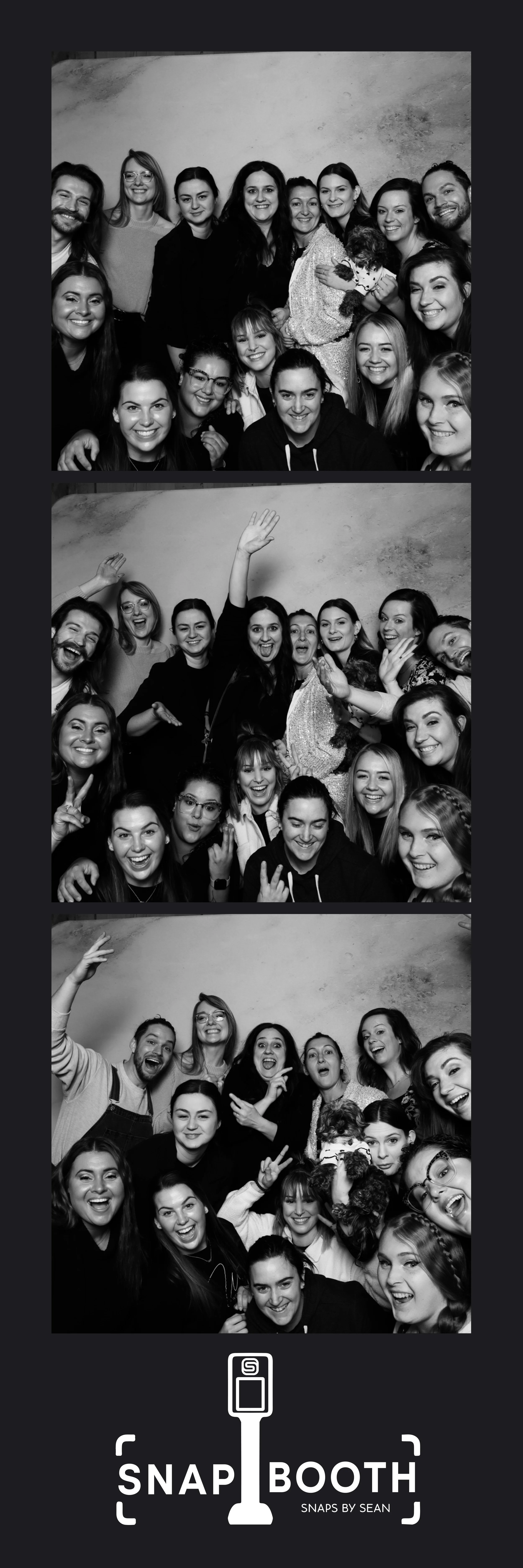 Group of people taking photos in a photo booth, with three different poses in black and white, and a logo for "Snap Booth" at the bottom.