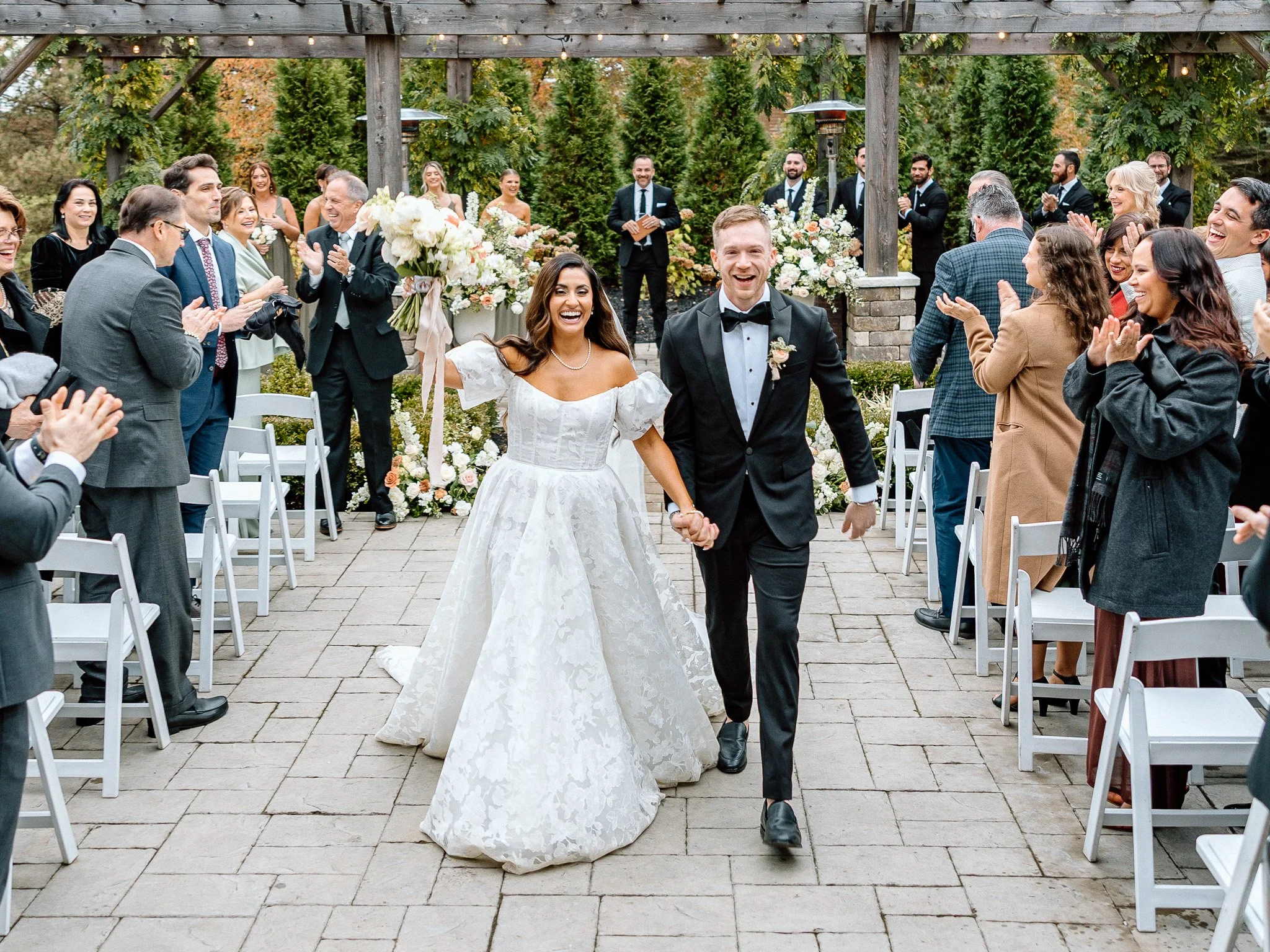 a happy bride and groom walk down the aisle on their wedding day celebrating their new marriage together