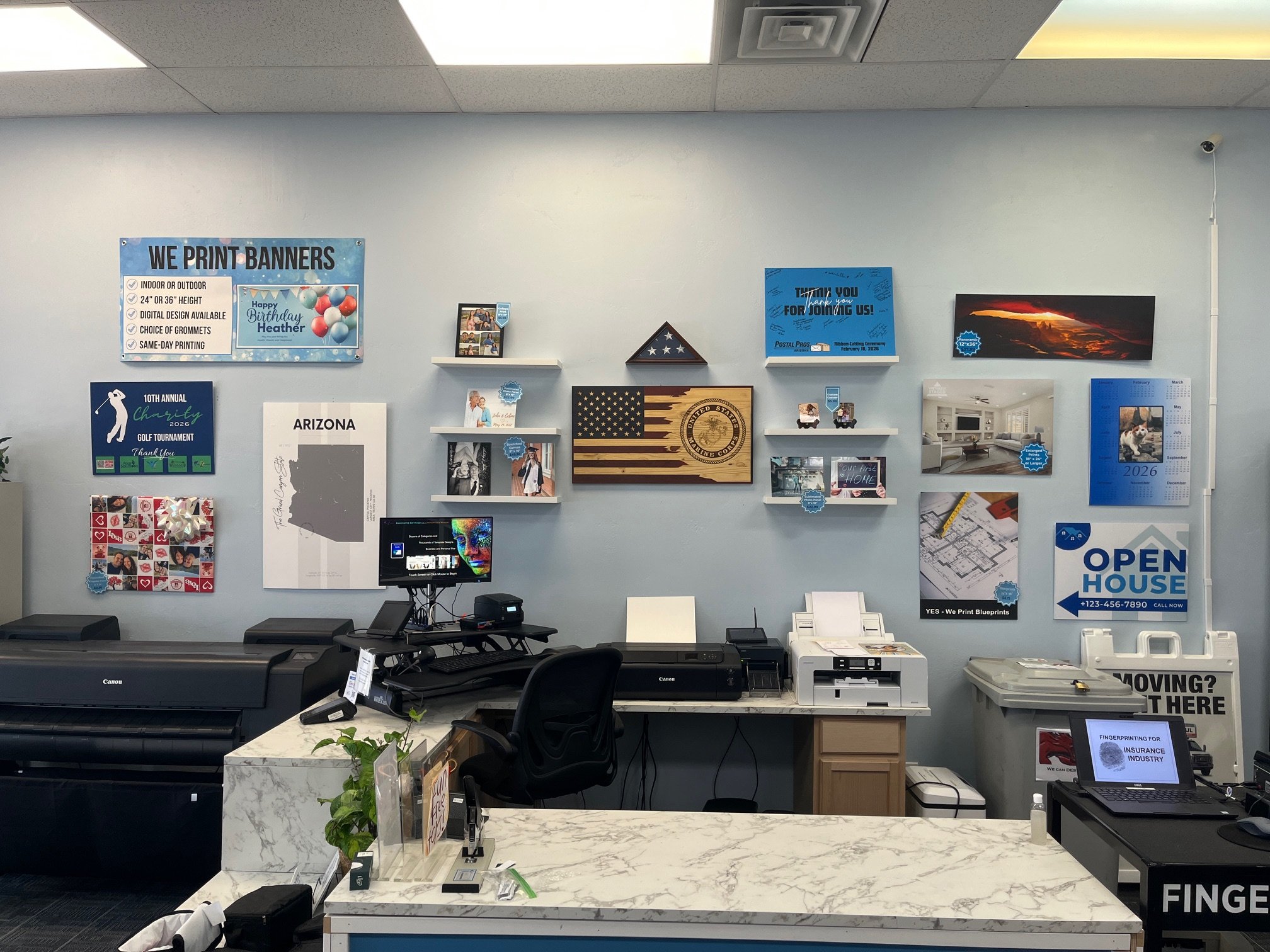 Wall with posters, banners, large phots, and blueprints displayed