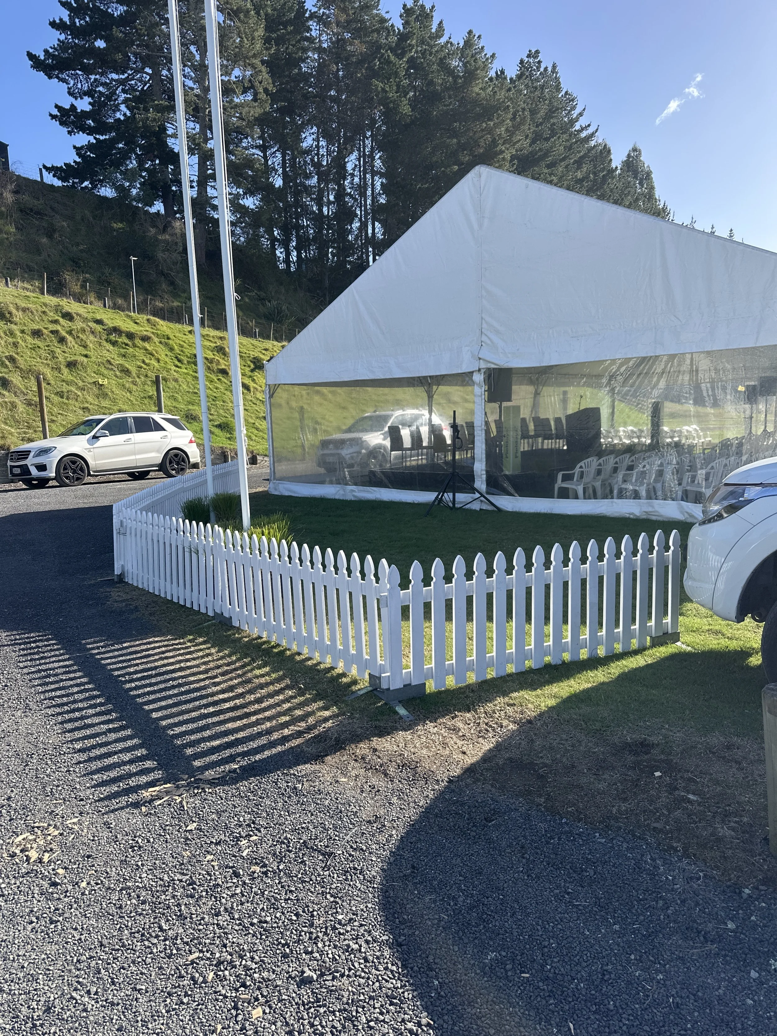 A large white event tent set up on grass, surrounded by Got-2-Go white picket fences for the Fieldays.