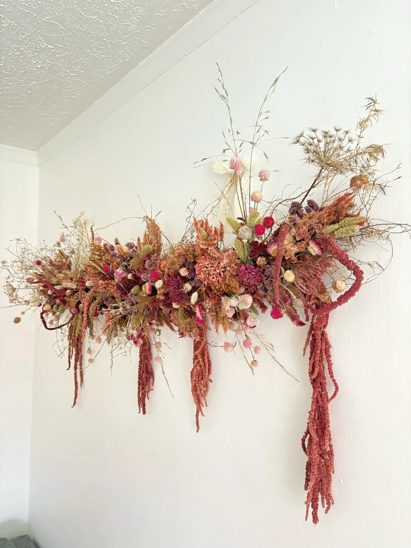 Pretty in pink wall hanging I made. Lots of dried flowers went into this.
 4 types of Celosia, gomphrena, amaranth, foxtail millet, dahlias, strawflower, queen annes lace, zinnias, nigella seed pods, poppy seed pods, hare&rsquo;s tail grass, pink fle