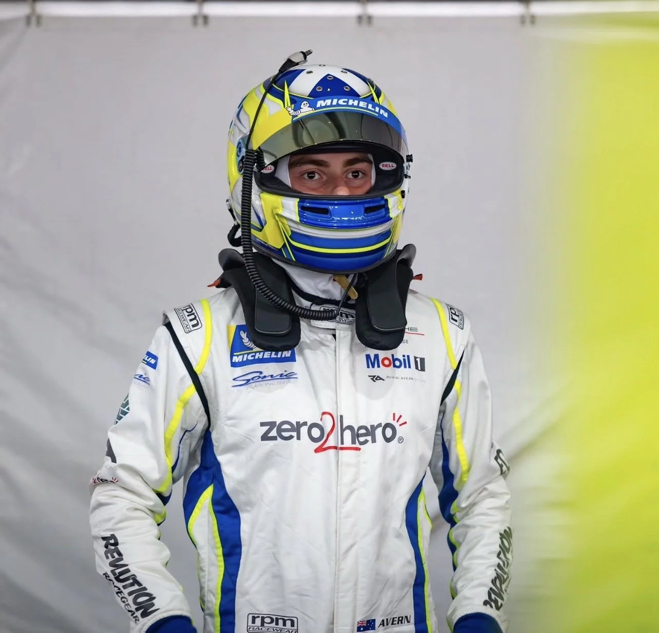 Ruairi Avern in racing suit and helmet, 2026 Porsche Michelin Sprint Challenge driver