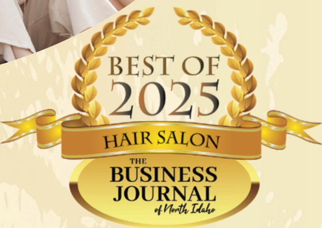 Award badge for 'Best of 2025 Hair Salon' by The Business Journal of North Idaho featuring a gold laurel wreath and ribbon.