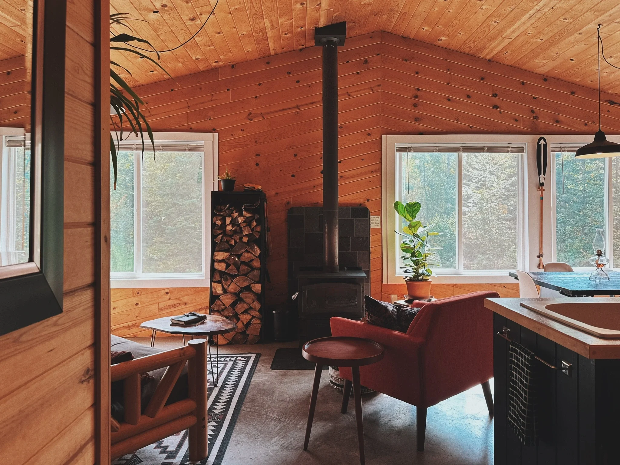 Our cedar-clad cabin in the Northwoods has beautiful vaulted ceilings, a wood burning stove, and all the firewood you could ever want