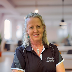 Katy Fraser, founder of Fraser Care, smiling outdoors – lived experience NDIS support provider