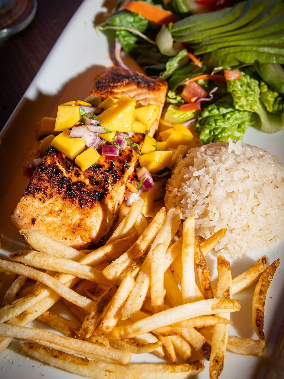 🔥Dinner? Handled. 

🐟Salmon glazed in mango magic, served up with avocado salad, crispy fries, and fluffy rice&mdash;because you deserve all the flavors. 

🔥Pair it with one of our margaritas and just like that&hellip; it&rsquo;s a vibe. 

✨Crave 