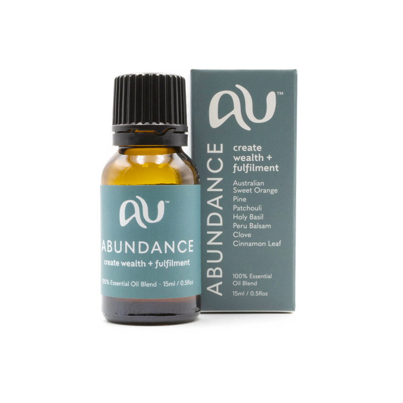 The Abundance Essential Oil Blend bottle is sitting next to its box on a white background. The box and bottle are branded in a teal colour.
