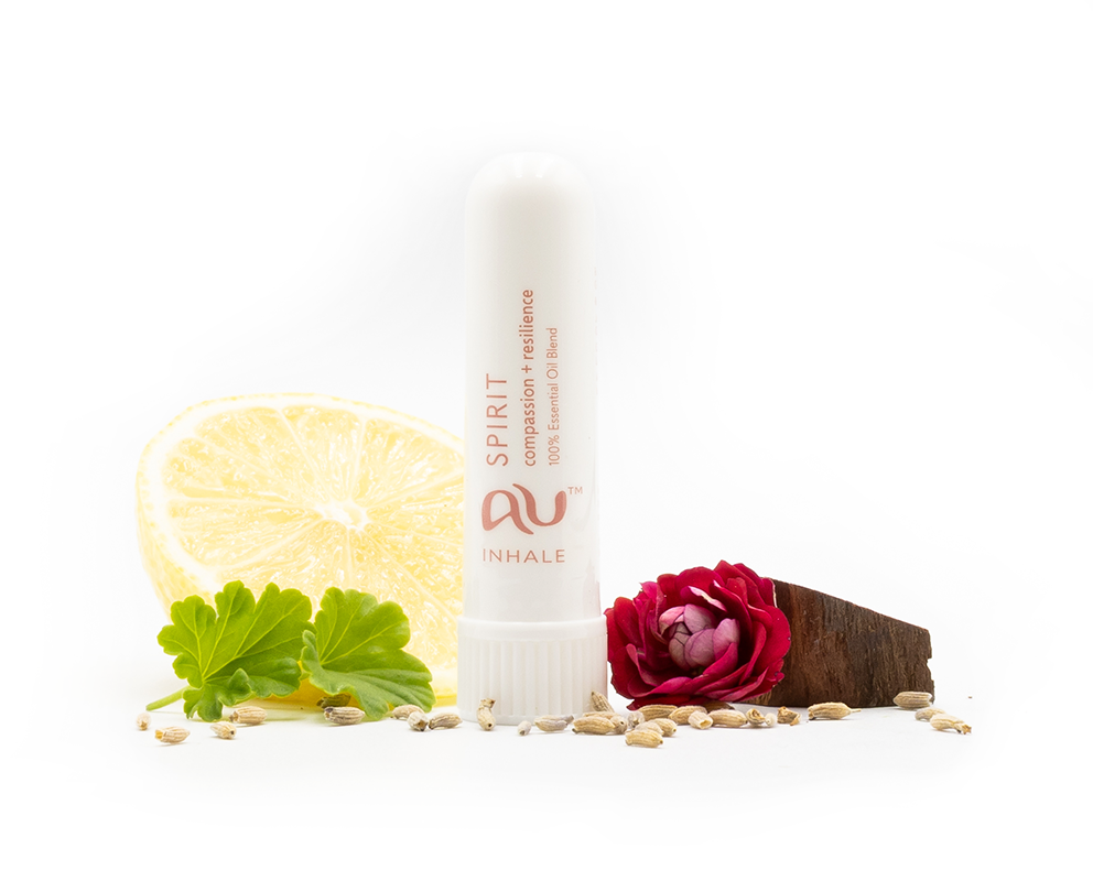 The Spirit Essential Oil inhaler is arranged on a white background surrounded by its ingredients - fruit, herbs and spices.