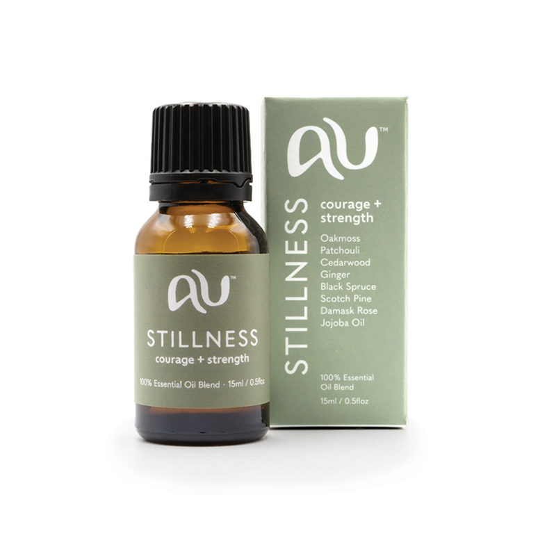 The Stillness Essential Oil Blend bottle is sitting next to its box on a white background. The box and bottle are branded in a sage colour.
