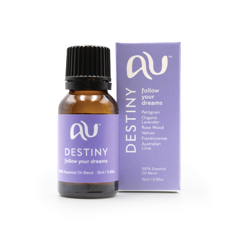 The Destiny Essential Oil Blend bottle is sitting next to its box on a white background. The box and bottle are branded in a soft blue-purle colour.