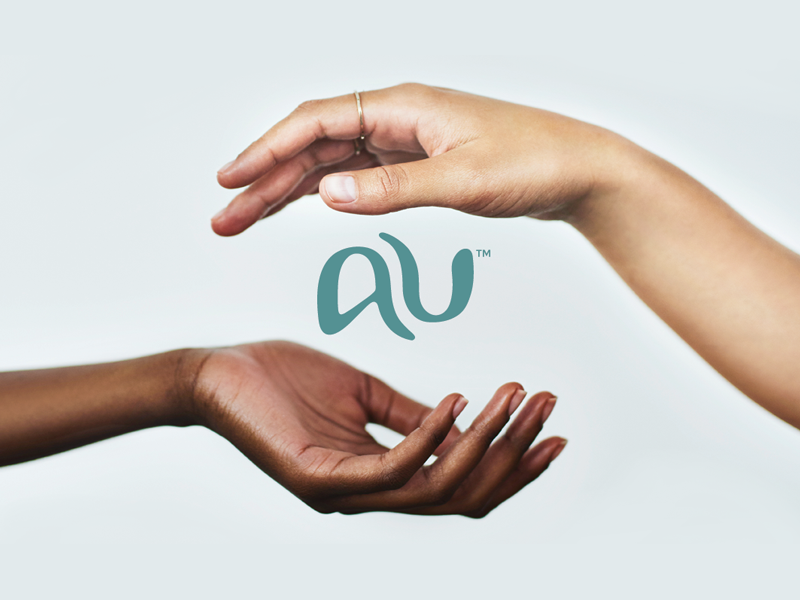 pale blue background, 2 hands form a circular frame around the AU logo submark.