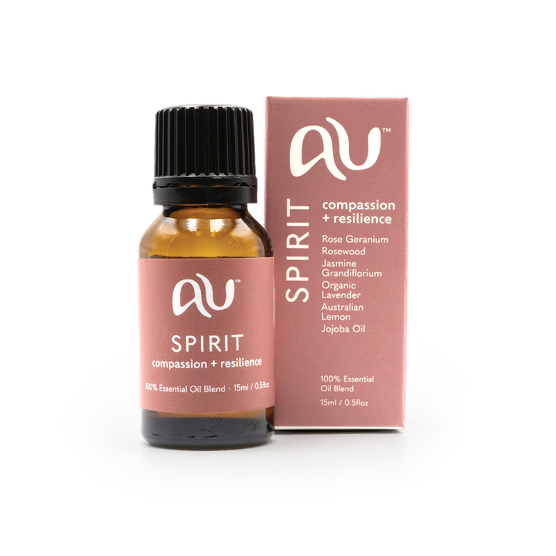 The Spirit Essential Oil Blend bottle is sitting next to its box on a white background. The box and bottle are branded in a soft maroon colour.