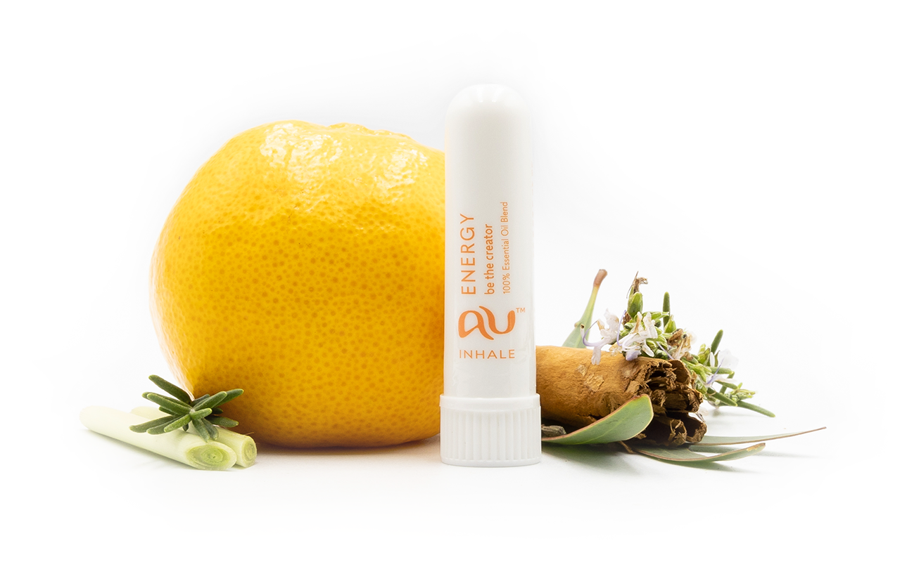 The Energy Essential Oil inhaler is arranged on a white background surrounded by its ingredients - fruit, herbs and spices.