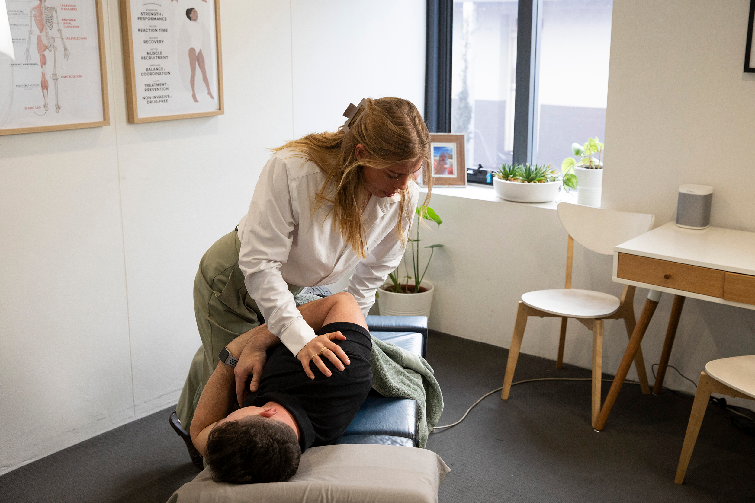 Chiropractor adjusting a clients lower back