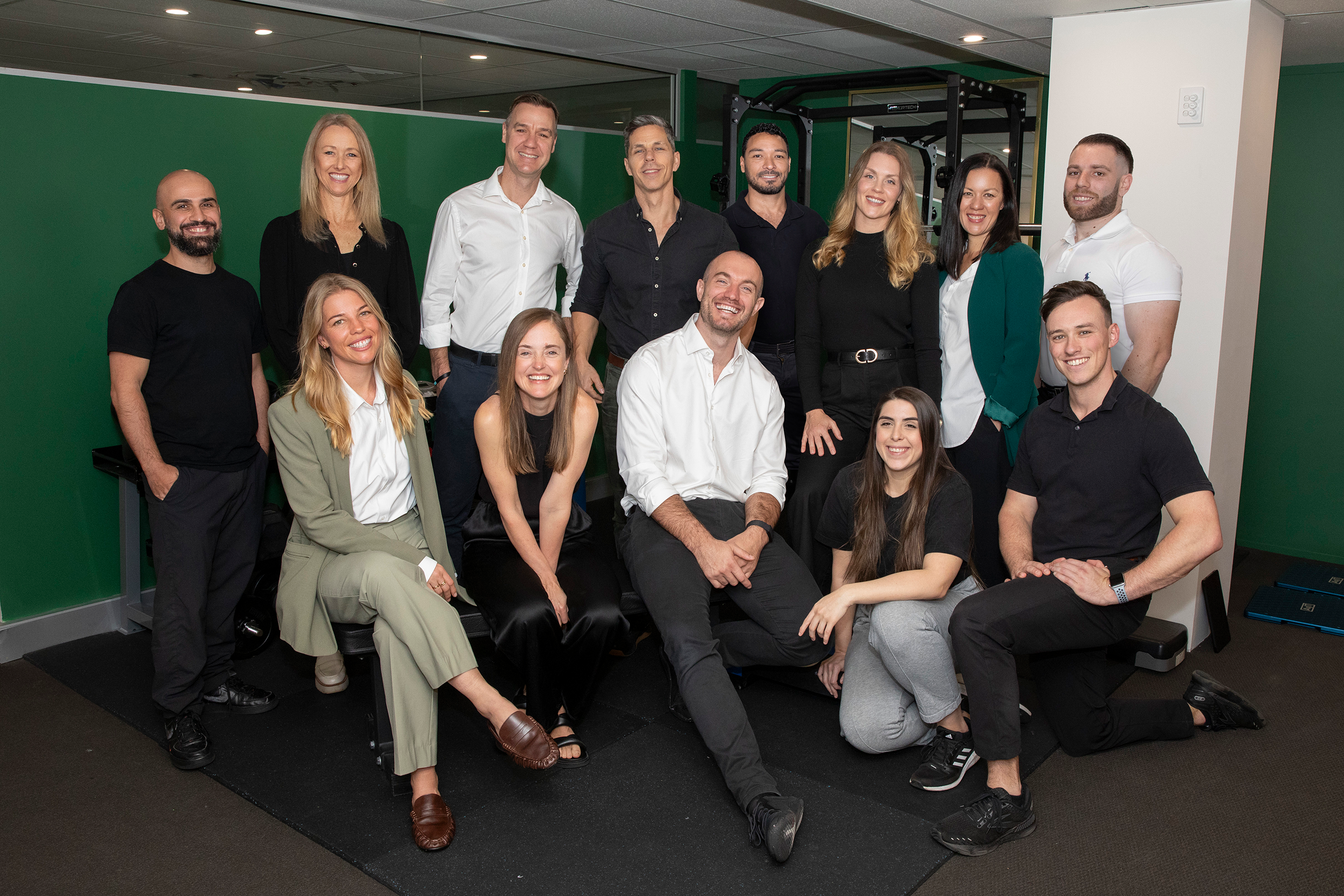 Team photo of 15 practitioners - chiropractors, acupuncturists, massage therapists, kinesiologists and physios