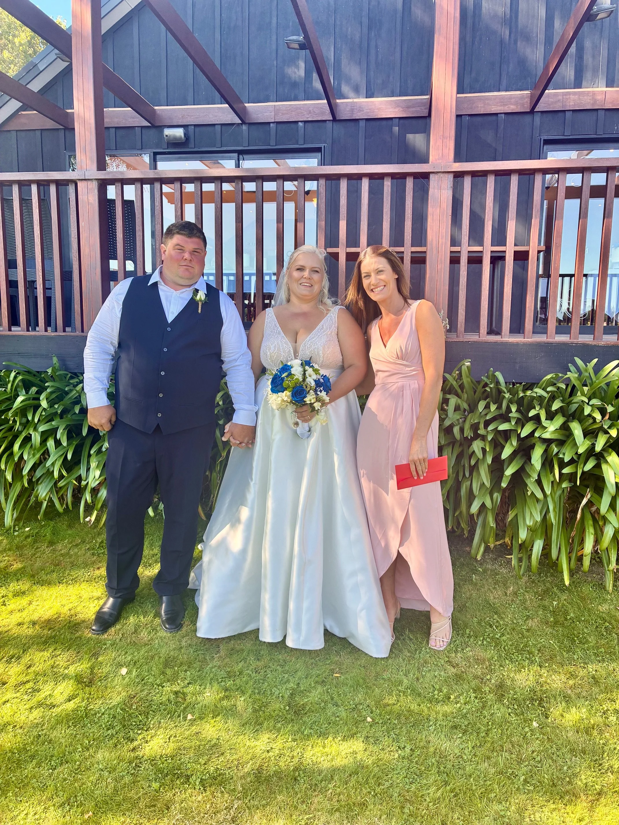 Bride and groom celebrating their wedding ceremony at Melton Estate with celebrant Ollie van der Pol.